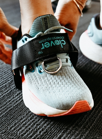 The image shows a person's foot, wearing the Clover Strap